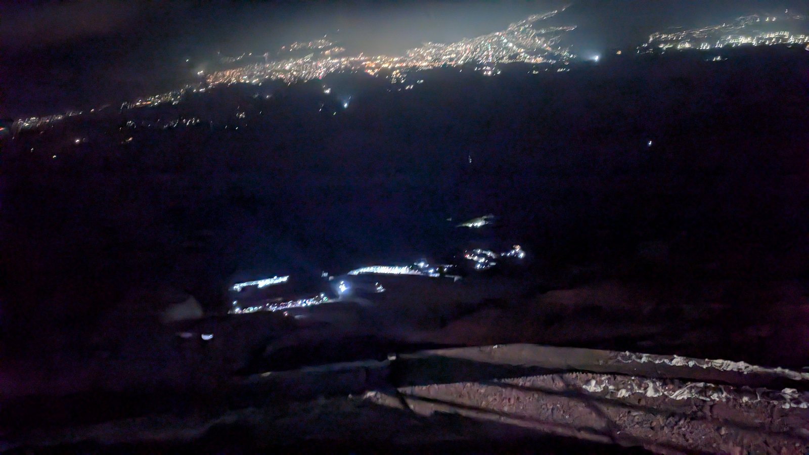 Distant town lights seen from the eighth station in the dark