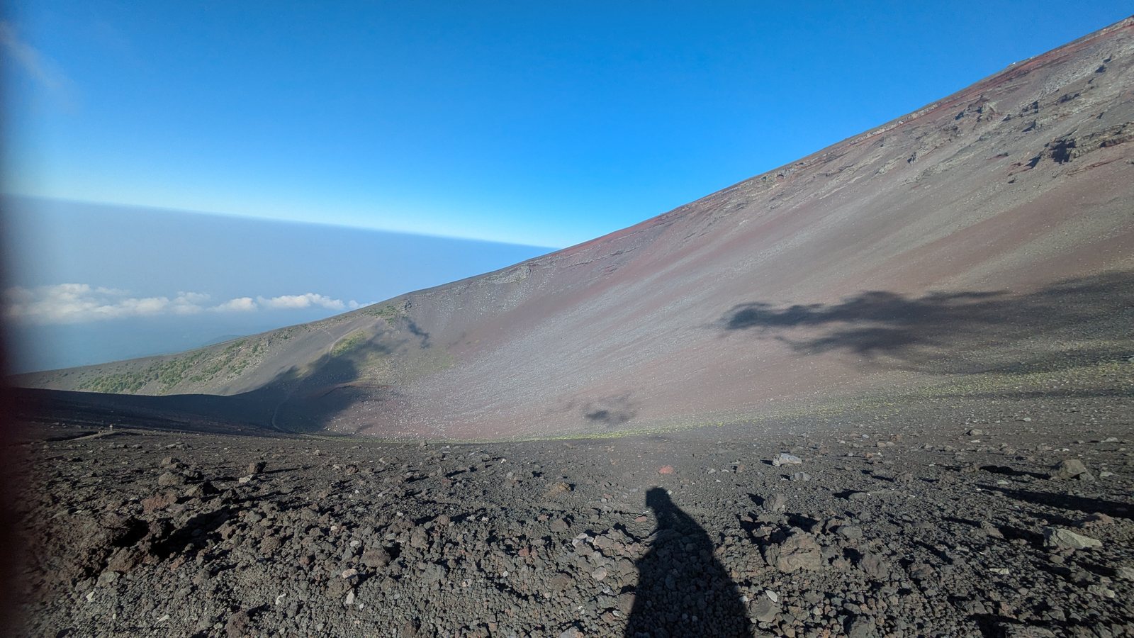 The rim of the Hoei crater in low morning light with a long shadow