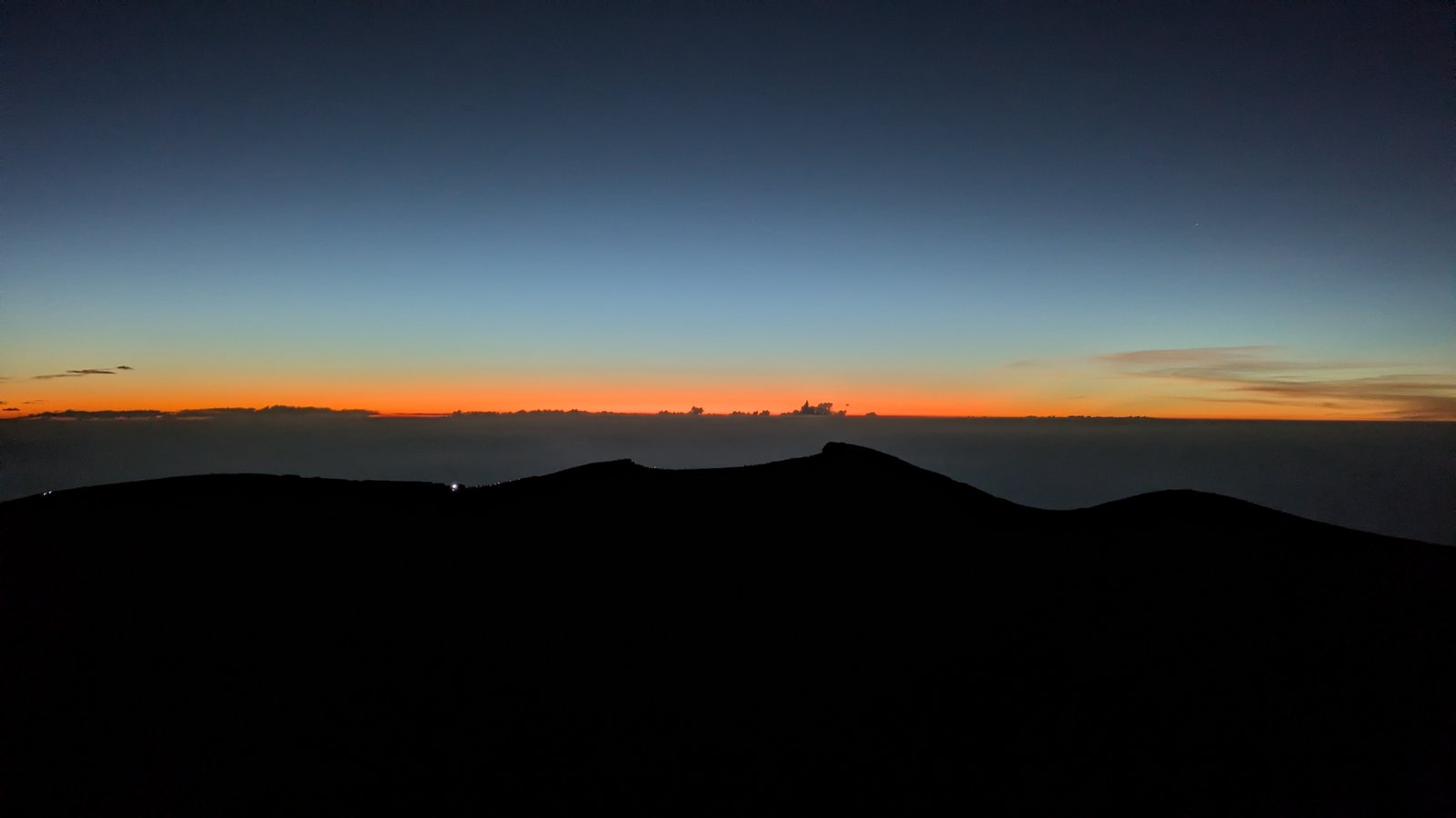 Orange light on the horizon before sunrise from the summit