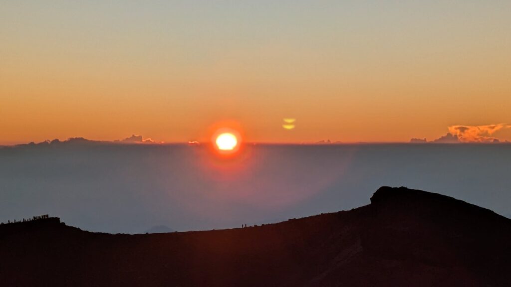 Sunrise seen from Kengamine across the crater of Mount Fuji