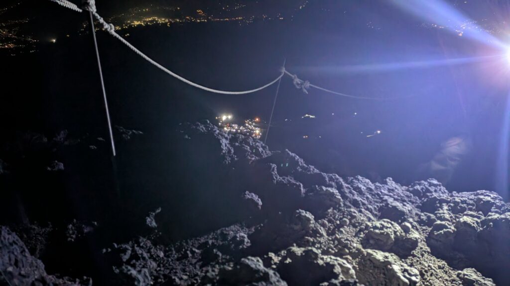 The Yoshida summit at night with town lights far below