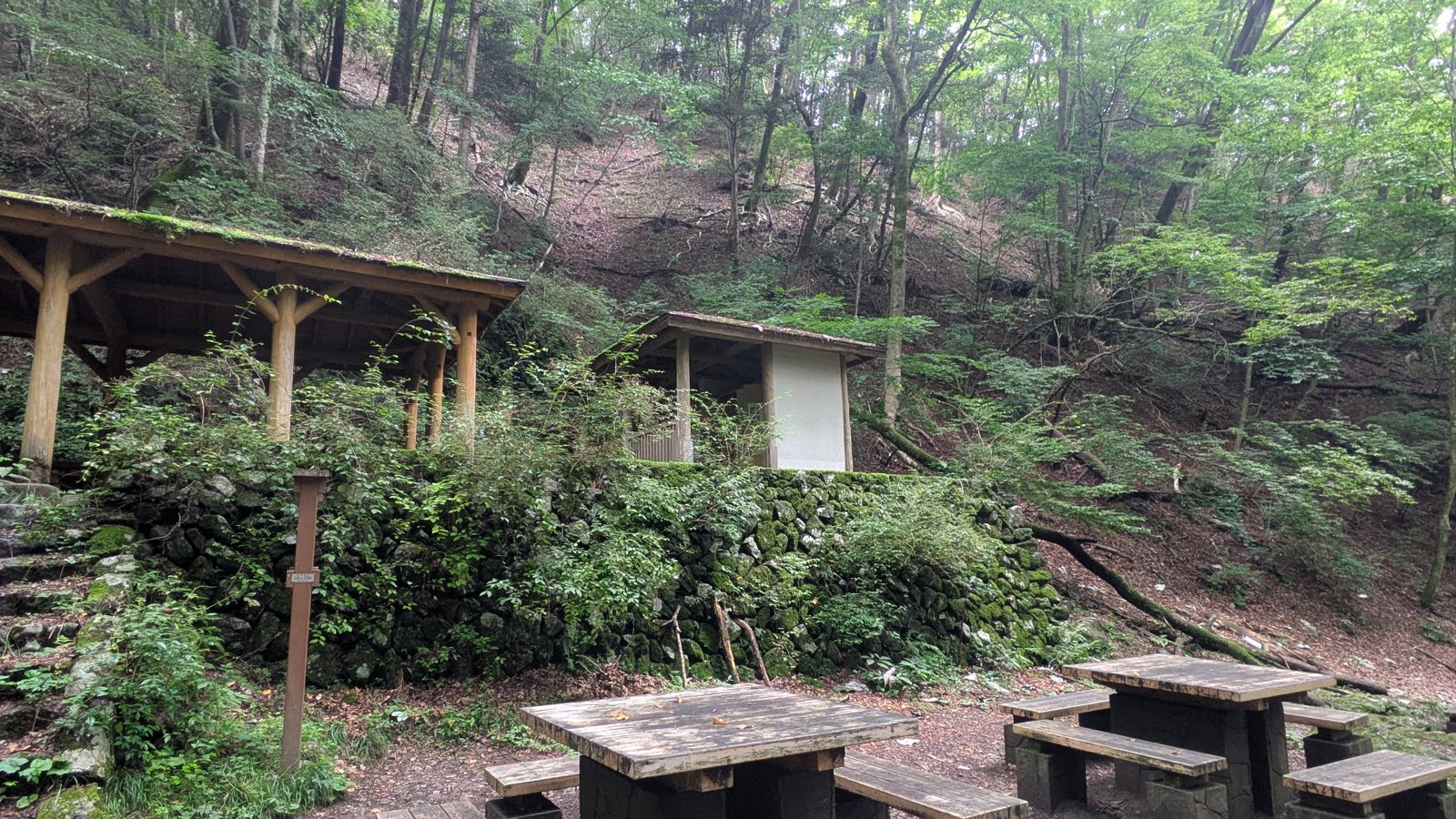 A wooden shelter with a toilet block beside the trail in the Rock Garden valley