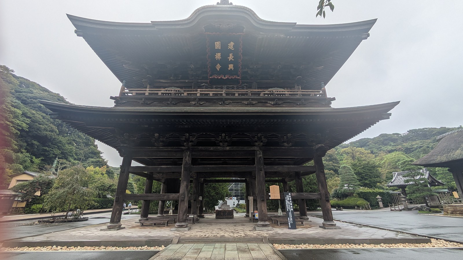 The large two-storey wooden Sanmon gate at Kencho-ji seen from the approach