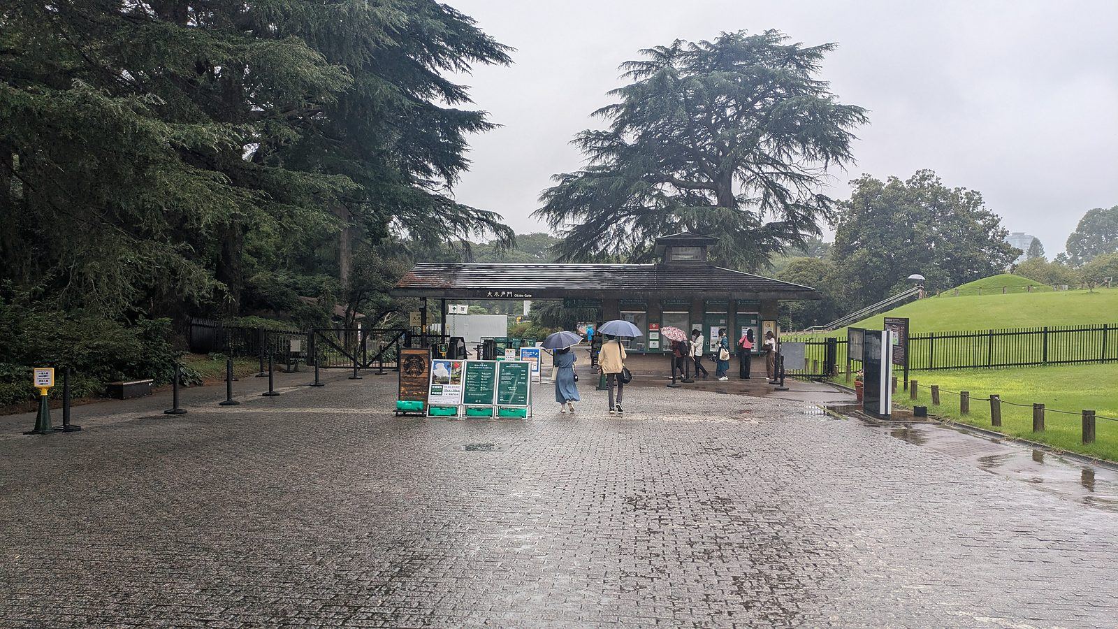 The ticket booth at Okido Gate with a grass mound and a flight of steps behind it
